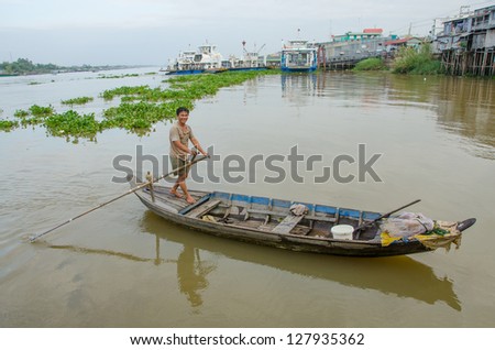 CHAU DOC, VIETNAM - JANUARY 2: Unidentified fisherman comes back from fishing in his wooden boat on January 2, 2013, in Chau Doc, Vietnam. Fishing is an important source of income in Vietnam