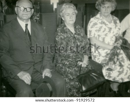 Vintage photo of elderly couple and adult daughter (sixties)