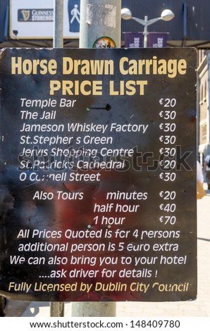 DUBLIN, IRELAND - JUNE 7: Horse drawn carriage price list in front of Guinness Storehouse, Dublin, Ireland on June 7, 2013