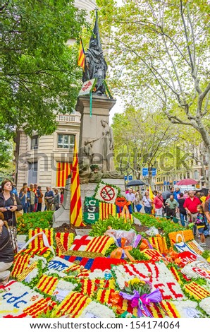 BARCELONA, SPAIN - SEPTEMBER 11: Catalan people participate in floral offerings to the monument of Rafael Casanova during the National Day of Catalonia, Barcelona, Spain on September 11, 2013