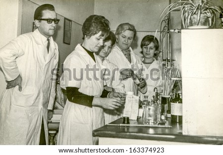 LODZ, POLAND, CIRCA 1950 - Vintage photo of group of medical university students wearing aprons during practical training, in Lodz, Poland, circa 1950