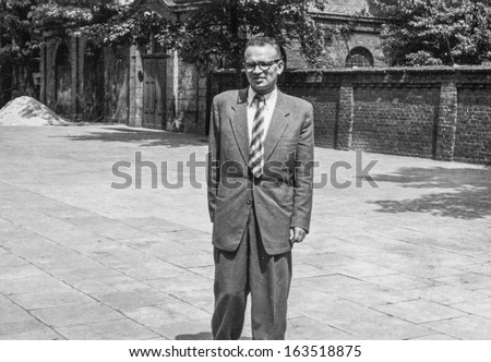 Vintage photo of man in formal suit outdoor (fifties)