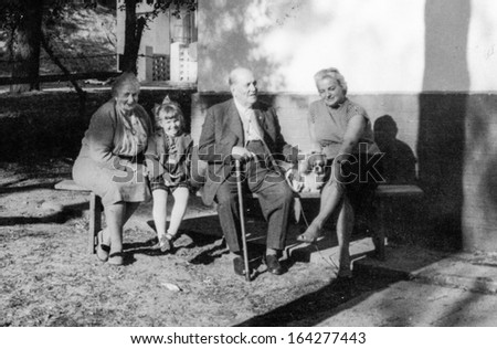 POLAND - CIRCA FIFTIES: vintage photo of unidentified family on bench, Poland, circa fifties