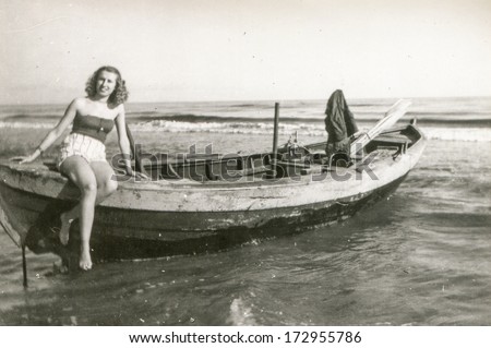 HERINGSDORF, GERMANY, CIRCA 1956 - Vintage photo of young woman on boat