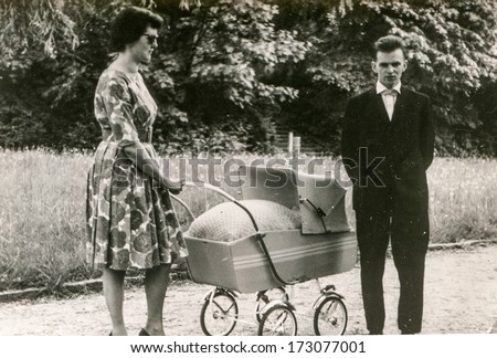 GERMANY, CIRCA FIFTIES - Vintage photo of parents with a baby in pram