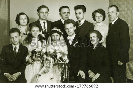 LODZ, POLAND, CIRCA SIXTIES - Vintage photo of newlyweds  with family and friends