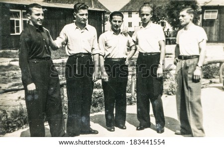 LODZ, POLAND, CIRCA 1960's: Vintage photo of group of men outdoor