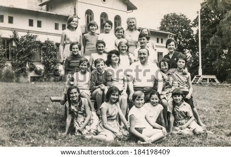 POLAND, CIRCA 1970\'s: Vintage photo of group of  young girls and teachers posing together  during a summer camp