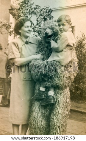 POLAND, CIRCA 1950\'s: Vintage photo of mother with little son posing with fake bear