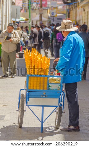 LA PAZ, BOLIVIA, MAY 8, 2014 - Street seller of ice cream sells his merchandise on busy Comercio street