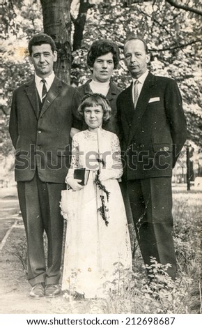 SIERADZ, POLAND - CIRCA 1950: Vintage photo of grandfather, parents and little girl at her First Communion.