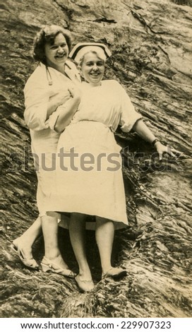 LODZ, POLAND, CIRCA FIFTIES - Vintage photo of nurse and young doctor outdoor