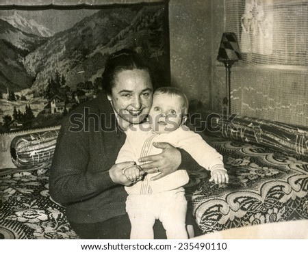 SZCZECINEK, POLAND, APRIL 12, 1962: Vintage photo of  grandmother with her baby grandchild