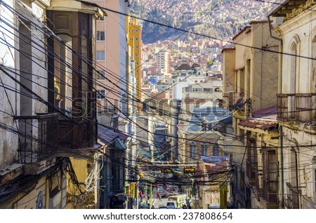 LA PAZ, BOLIVIA, MAY 8, 2014: A tangle of electric cables hangs over the street