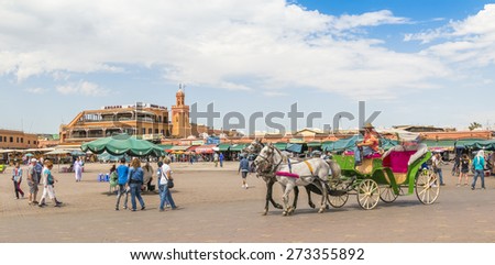 MARRAKESH, MOROCCO, APRIL 3, 2015: Jemaa el-Fnaa square -  Horse drawn carriage waits for tourists