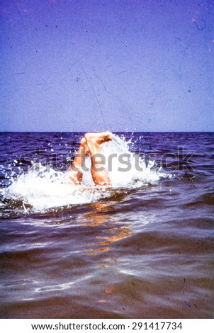 Vintage photo (scanned reversal film) of man diving in sea, early 1970\'s