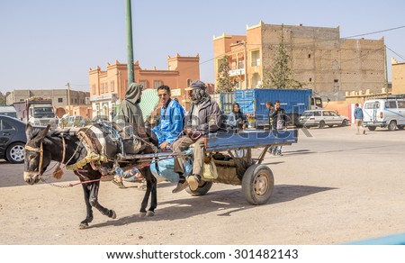 TAZNAKHT,MOROCCO - APRIL 10, 2015: Local men travel on donkey powered cart