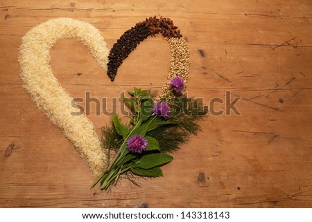 Rice, herbs and spices in a heart shape, warm colours