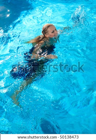 Young happy woman splashing water