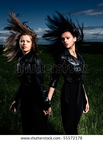 Portrait beautiful girls with great fly-away hair on a background of a landscape