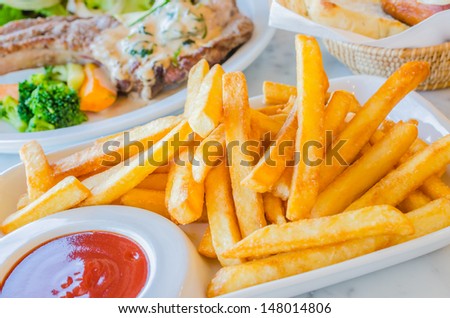 Fried Potato in white dish with tamato sauce