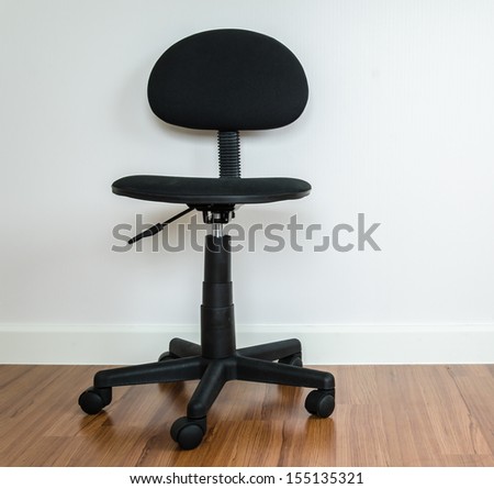 Office chair with white wallpaper