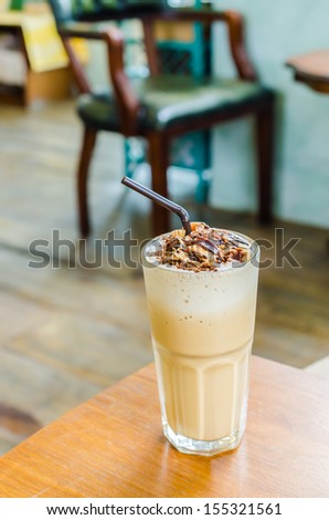 Coffee frappe with almond on top in coffee shop