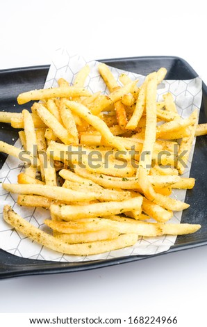 French fried in black dish on white background