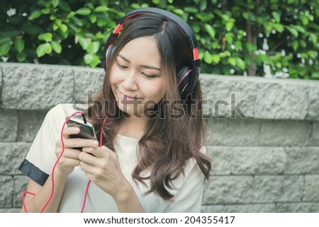 Girl listen to music. Process vintage style picture