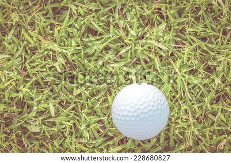 Golf ball on green grass  - vintage effect style pictures