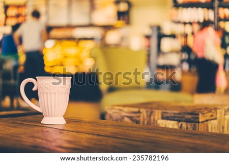 Coffee mug on wooden table in coffee shop - Vintage effect style pictures processing