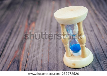 Hour glass on wooden background - vintage effect style pictures
