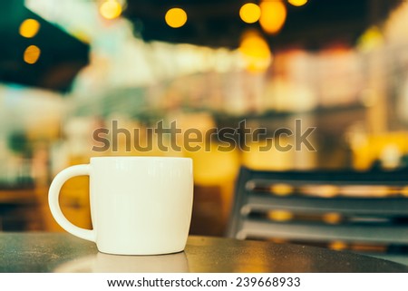 Coffee cup in coffee shop on wooden table - Vintage effect style pictures