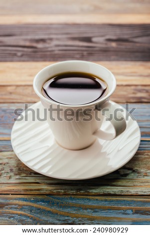 Coffee cup on wood table - vintage effect style pictures