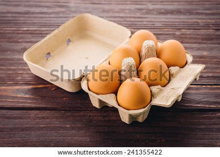 eggs pack on wood background