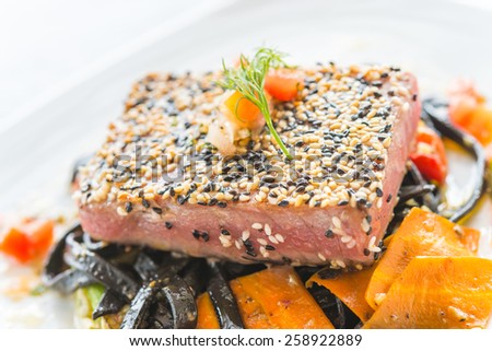 Grilled Tuna fish meat steak with black spaghetti - soft focus point