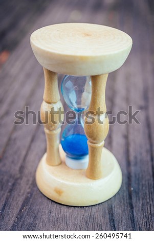 Hour glass on wooden background - vintage effect style pictures