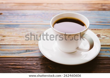 Coffee cup on wooden table - vintage effect pictures