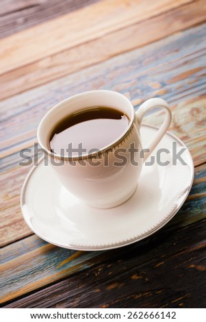 Coffee cup on wooden table - Vintage effect