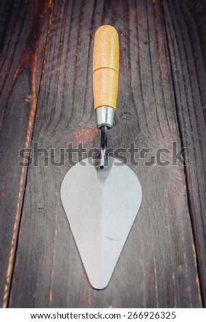 Trowel on wooden background - vintage effect style pictures
