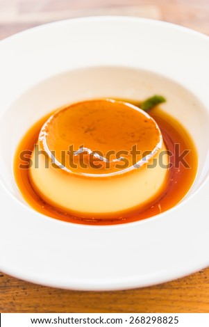 Caramel custard pudding in white plate - selective focus point