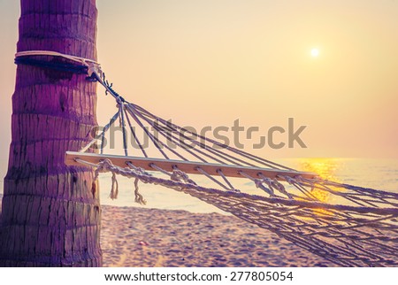 Hammock sunset on the beach - vintage filter