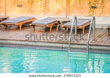 Hotel resort pool on sunrise time - vintage filter and sunflare effect