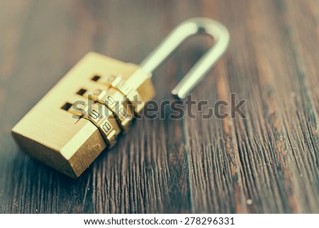Close up pad lock on wooden background - vintage effect style pictures