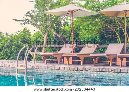 Resort pool with umbrella and chair - vintage filter effect