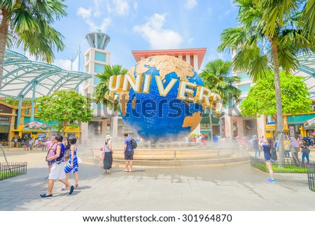 SINGAPORE - JULY 20: Tourists and theme park visitors taking pictures of the large rotating globe fountain in front of Universal Studios on JULY 20, 2015 in Sentosa island, Singapore