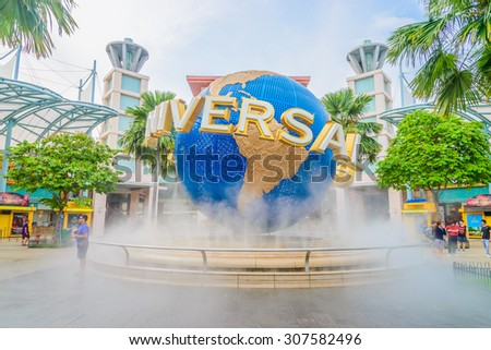 SINGAPORE - August 6: Tourists and theme park visitors taking pictures of the large rotating globe fountain in front of Universal Studios on August 6, 2015 in Sentosa island, Singapore