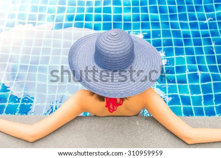 Young Women wear hat in hotel swimming pool - Sunflare filter effect
