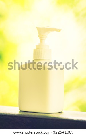 Lotion bottle with outdoor view - vintage filter effect