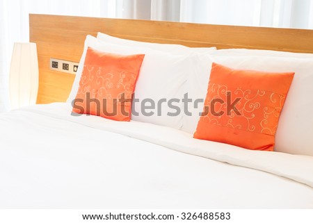 Beautiful luxury bedroom interior with orange pillow decoration in hotel resort